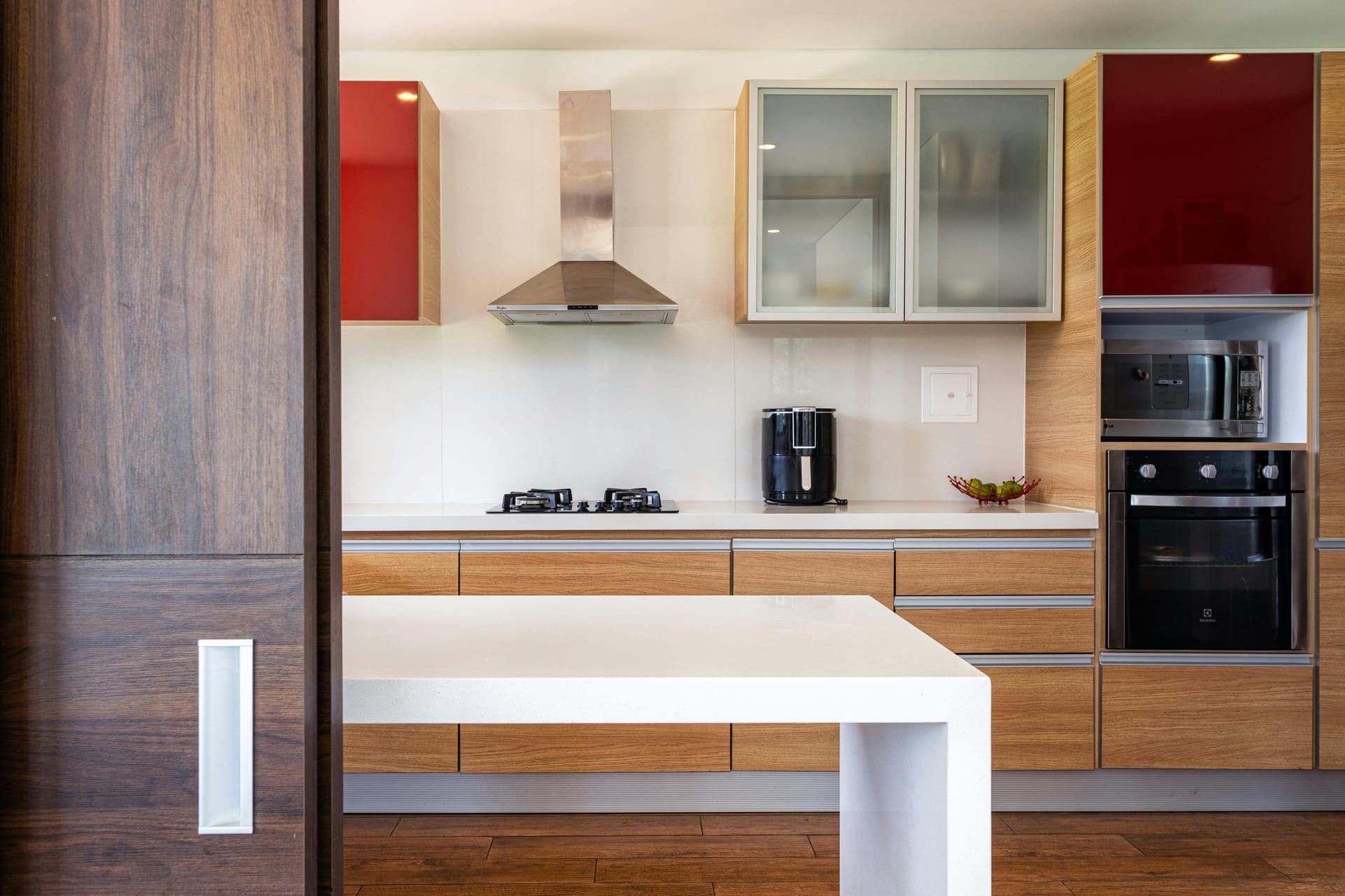 Modern kitchen renovation with wood cabinets and stainless appliances